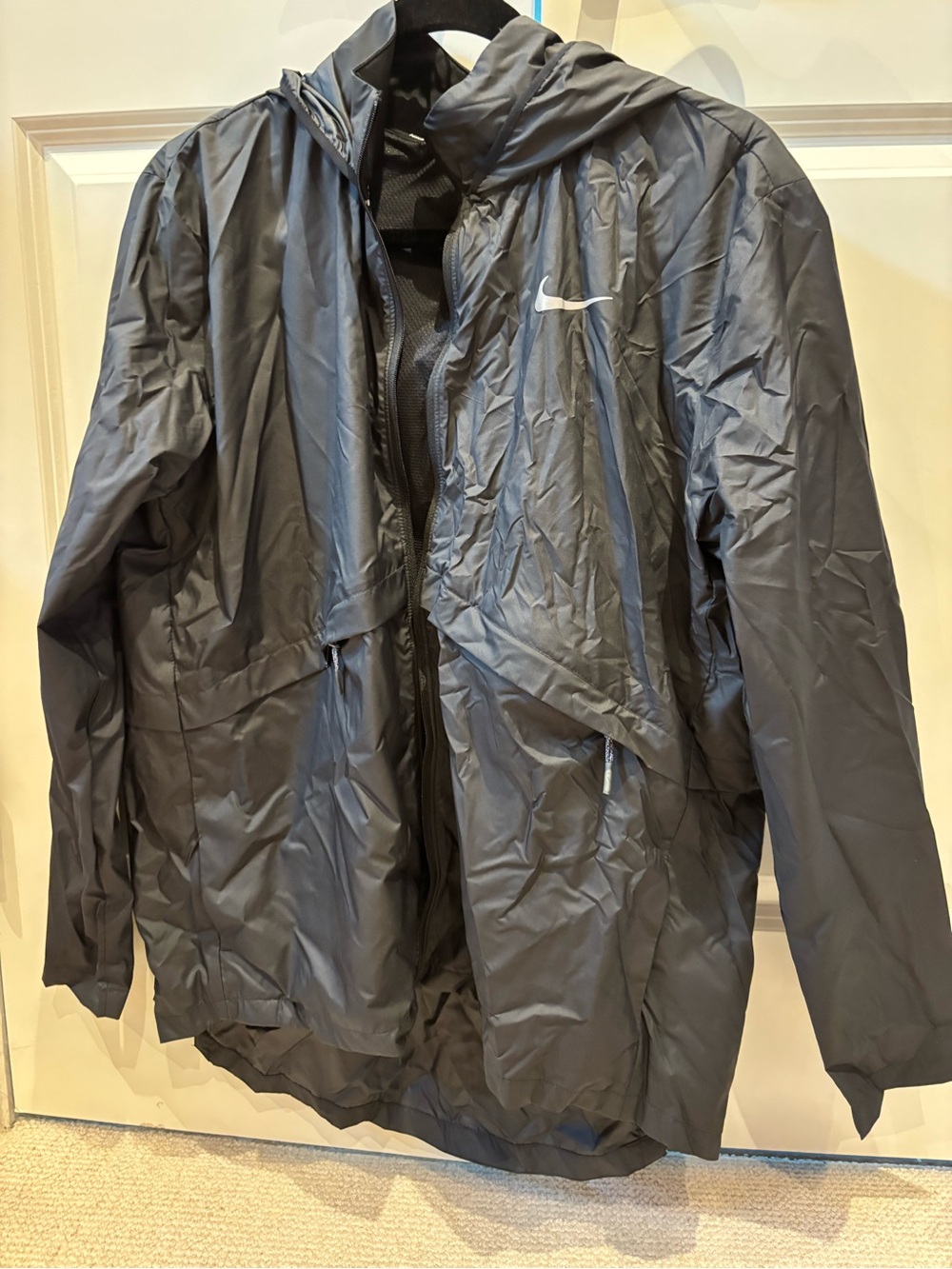 Nike Black Hooded Rain Jacket with Reflective Swoosh. Longer in back, hood.